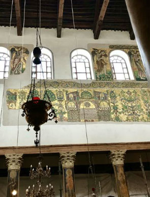 Part of restored mosaic and hanging oil lamps